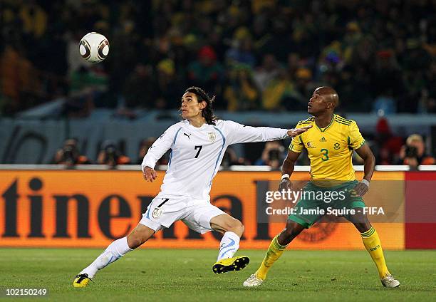 Edinson Cavani of Uruguay is challenged by Tsepo Masilela of South Africa during the 2010 FIFA World Cup South Africa Group A match between South...