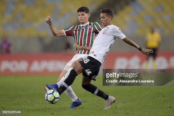Ayrton Lucas of Fluminense struggles for the ball with Pedrinho of Corinthians during the match between Fluminense and Corinthians as part of...