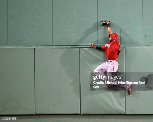 Chris Young of the Arizona Diamondbacks slams into the center field wall of Fenway Park after making a catch that robbed Victor Martinez of the...