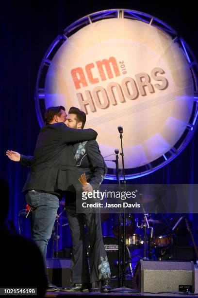 Storme Warren presents an award to Jeremy Dylan accepting for Jim Reeves onstage during the 12th Annual ACM Honors at Ryman Auditorium on August 22,...