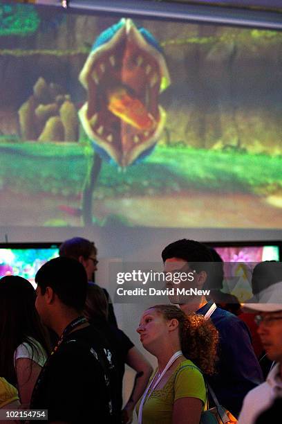 People await their turn to try out new games in the Nintendo exhibit in the annual Electronic Entertainment Expo at the Los Angeles Convention Center...