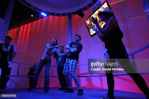 People play a dance game at the MTV Games Dance Central exhibit in the annual Electronic Entertainment Expo at the Los Angeles Convention Center on...