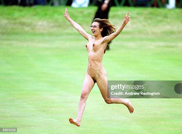 Female streaker on the 18th green as Tiger Woods of the USA makes his final putt during the final round of the British Open Golf Championships at the...