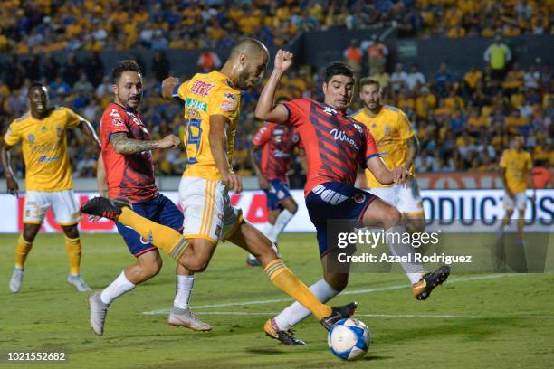 Guido Pizarro of Tigreskicks the ball over Enrique Perez of Veracruz during the 6th round match between Tigres UANL and Veracruz as part of the...