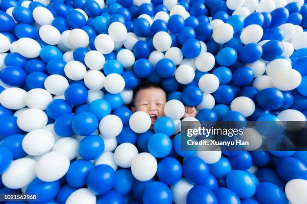 lovely little boy playing joyfully in ball pit - who could play young han solo stock pictures, royalty-free photos & images