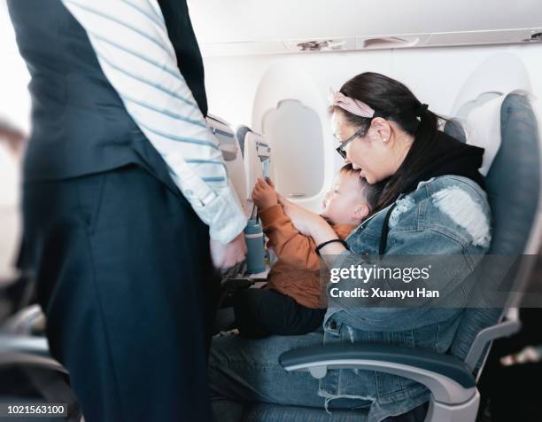 the first time a mother took her child on a plane - ekonomiklass bildbanksfoton och bilder