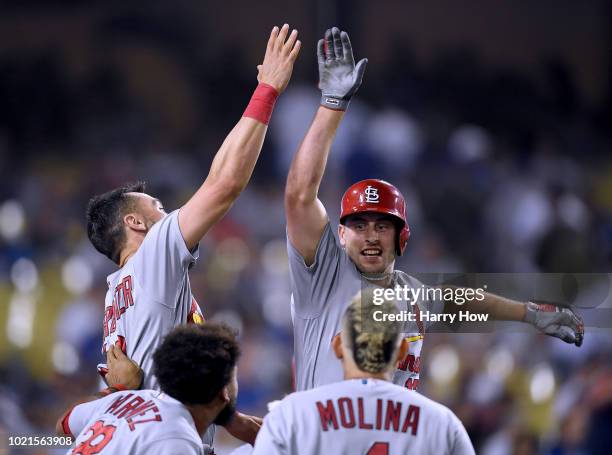 Paul DeJong of the St. Louis Cardinals celebrates his two run homerun with Matt Carpenter, Jose Martinez and Yadier Molina to take a 3-1 lead over...