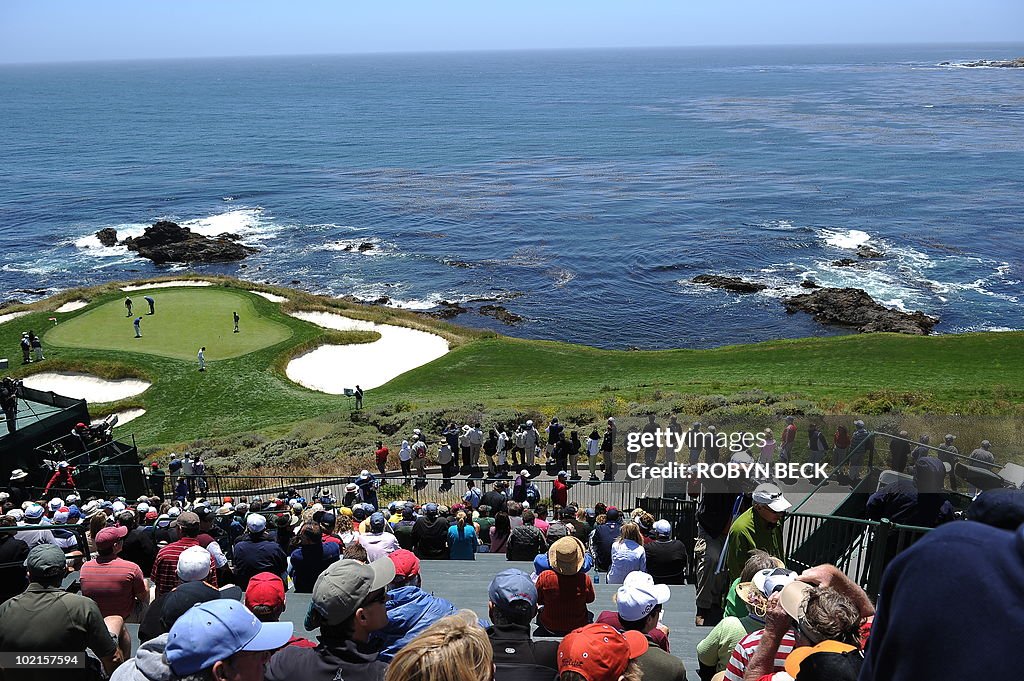 Spectators watch action on the 7th fairw