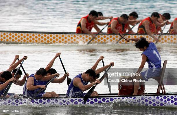 People row Dragon Boats to mark the Duanwu Festival, or the Dragon Boat Festival during the 8th Yingbin Rowing Contest at the Yingbin Peninsula on...