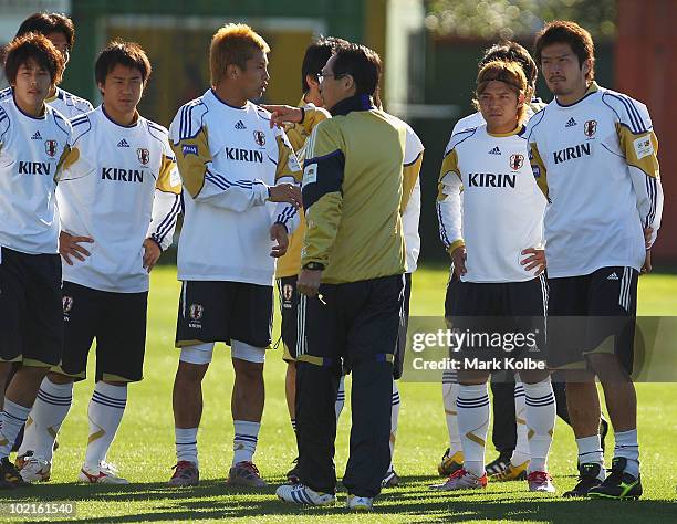 The players look on as Japan coach Takeshi Okada gives instructions at a Japan training session during the FIFA 2010 World Cup at Outeniqua Stadium...