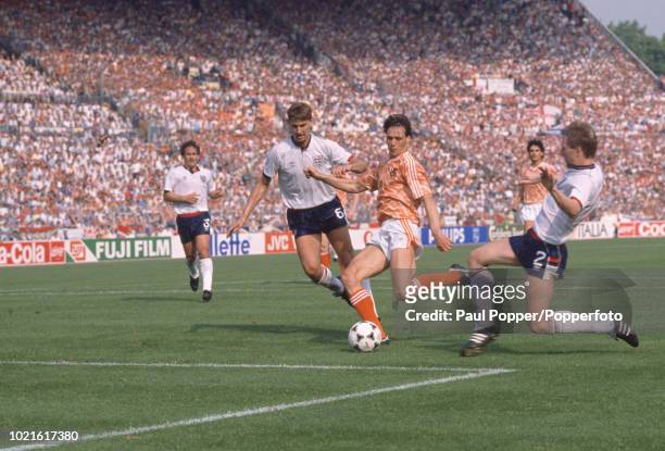 Marco van Basten of the Netherlands scores as Gary Stevens and Tony Adams attempt to stop him during the UEFA Euro 88 Group 2 match at the...