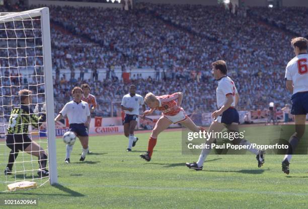 Oleksiy Mykhaylychenko of the Soviet Union scores past Chris Woods of England during the UEFA Euro 88 Group 2 match at the Waldstadion on June 18,...