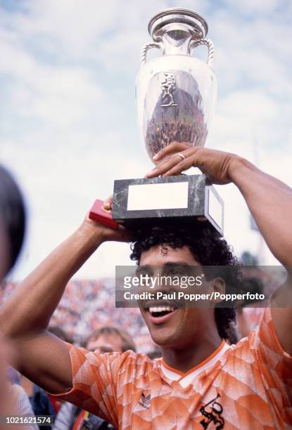 Frank Rijkaard of the Netherlands celebrates with the trophy after the UEFA Euro 88 Final between the Soviet Union and the Netherlands at the...