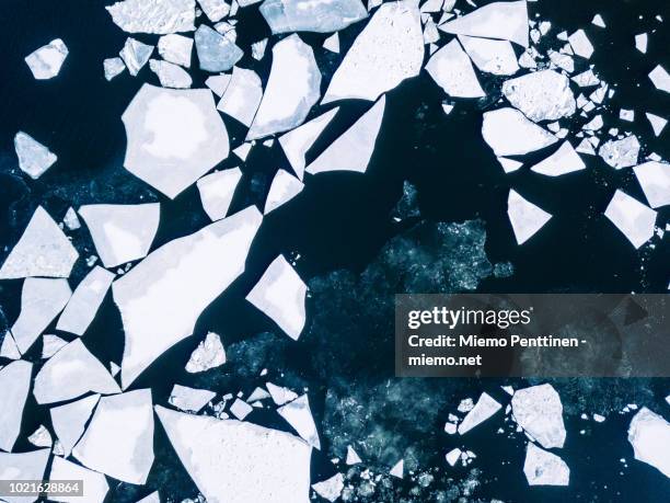 wintery top-down aerial view of cracked ice on baltic sea around helsinki - ice floe stock pictures, royalty-free photos & images
