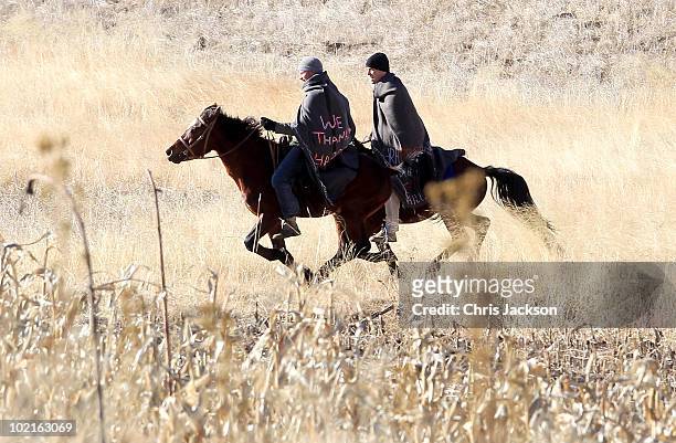 Prince Harry and Prince William ride horses as they arrive to visit a child education centre on June 17, 2010 in Semonkong, Lesotho. The two Princes...