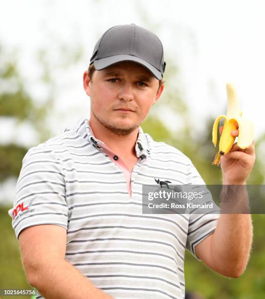 Eddie Pepperell of England eats a banana while walking off the 12th hole during Day One of D+D REAL Czech Masters at Albatross Golf Resort on August...