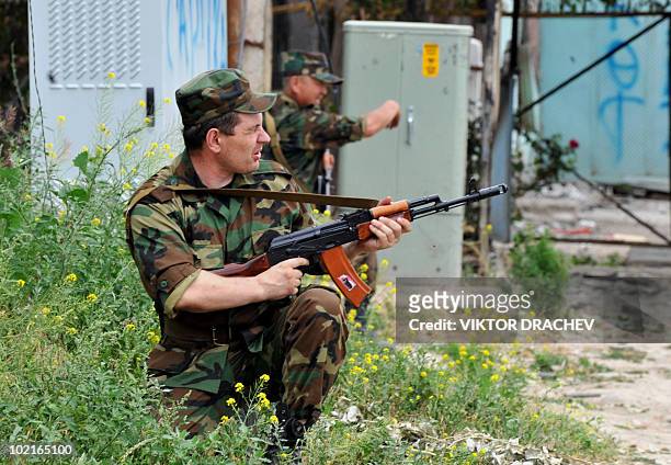 Kyrgyz special police officers patrol near a check point in Osh on June 17, 2010. Deadly inter-ethnic clashes that erupted in Kyrgyzstan a week ago...