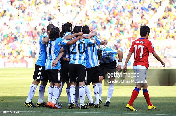 Lee Chung-Yong of South Korea walks past Argentina players celebrating an own goal by Park Chu-Young during the 2010 FIFA World Cup South Africa...