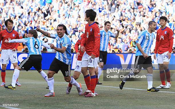 Carlos Tevez of Argentina celebrates an own goal by Park Chu-Young of South Korea during the 2010 FIFA World Cup South Africa Group B match between...