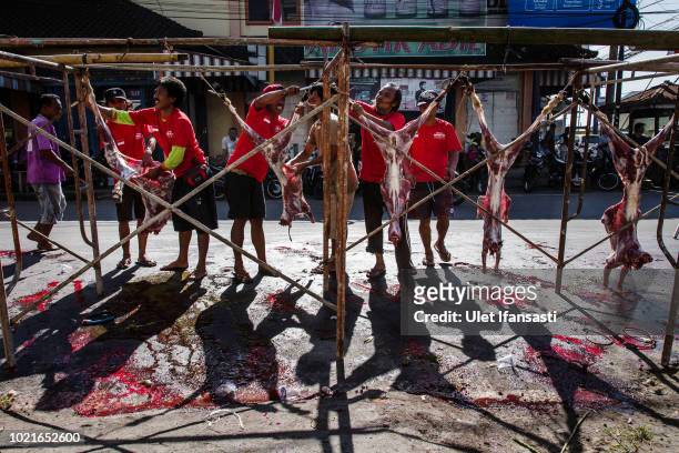 Indonesian Muslims butchers goats during celebrations for Eid al-Adha in Masbagig on August 23, 2018 in Lombok island, Indonesia. Thousands of...