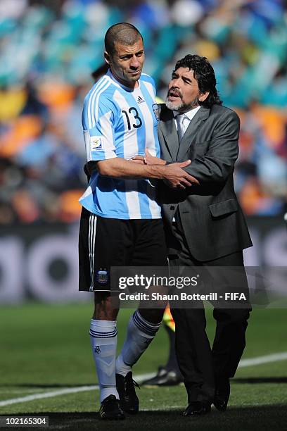 Diego Maradona head coach of Argentina gives instructions to Walter Samuel of Argentina during the 2010 FIFA World Cup South Africa Group B match...