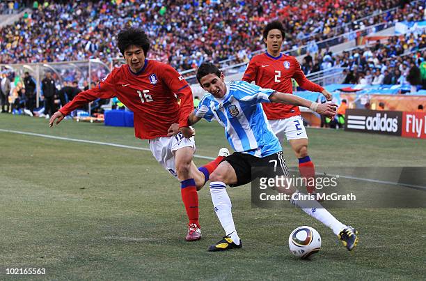 Angel Di Maria of Argentina comes under pressure from Ki Sung-Yueng and Oh Beom-Seok of South Korea during the 2010 FIFA World Cup South Africa Group...