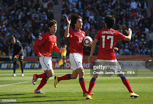 Lee Chung-Yong of South Korea celebrates scoring his team's first goal with team mates Park Chu-Young and Park Ji-Sung during the 2010 FIFA World Cup...