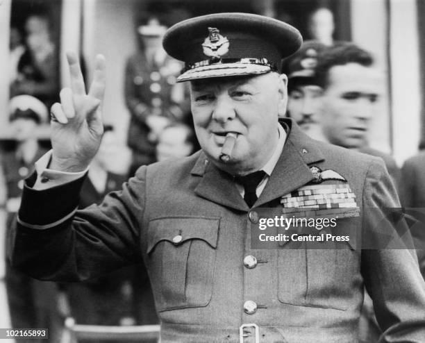 Winston Churchill gives his famous v-sign as he opens the new headquarters of 615 Squadron of the RAAF at Croydon, 1948.