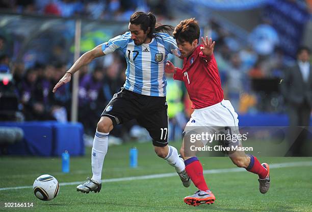 Park Ji-Sung of South Korea clashes with Jonas Gutierrez of Argentina during the 2010 FIFA World Cup South Africa Group B match between Argentina and...