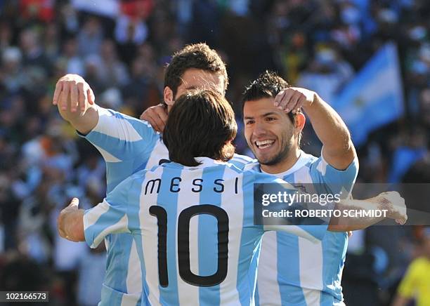 Argentina's striker Lionel Messi celebrates with Argentina's striker Gonzalo Higuain and Argentina's striker Sergio Aguero after Higuain scored his...