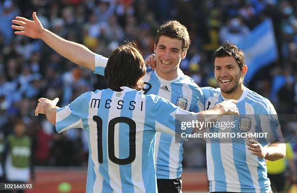 Argentina's striker Lionel Messi celebrates with Argentina's striker Gonzalo Higuain and Argentina's striker Sergio Aguero after Higuain scored his...