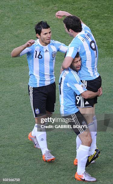 Argentina's striker Gonzalo Higuain celebrates a goal with Argentina's striker Sergio Aguero during to Group B first round 2010 World Cup football...