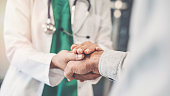 Health worker holding patient's hand