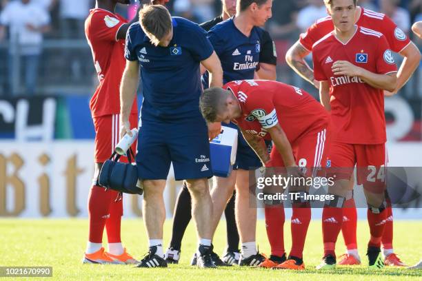 Lewis Holtby of Hamburger SV receives medical help during the DFB Cup first round match between TuS Erndtebrueck and Hamburger SV at Leimbachstadion...