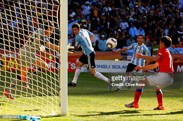 Gonzalo Higuain of Argentina heads in his third goal and his side's fourth during the 2010 FIFA World Cup South Africa Group B match between...