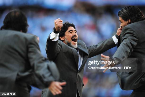 Diego Maradona head coach of Argentina celebrates a goal with team mates after the 2010 FIFA World Cup South Africa Group B match between Argentina...