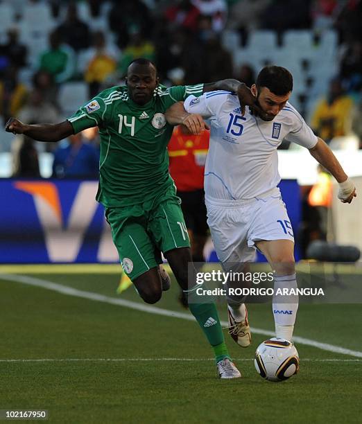 Nigeria's midfielder Sani Kaita and Greece's defender Vasilis Torosidis fight for the ball during the Group B first round 2010 World Cup football...