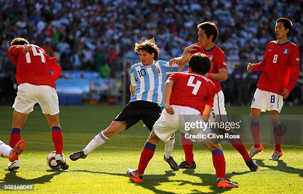 Lionel Messi of Argentina takes on the South Korea defence during the 2010 FIFA World Cup South Africa Group B match between Argentina and South...