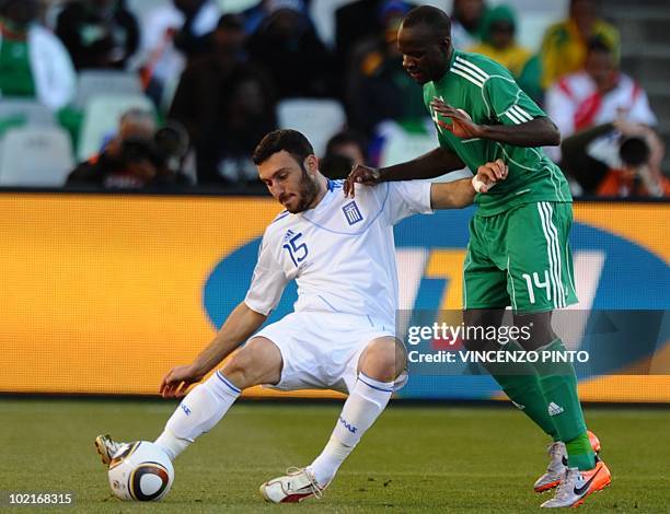 Greece's defender Vasilis Torosidis is challenged for the ball by Nigeria's midfielder Sani Kaita during the Group B first round 2010 World Cup...
