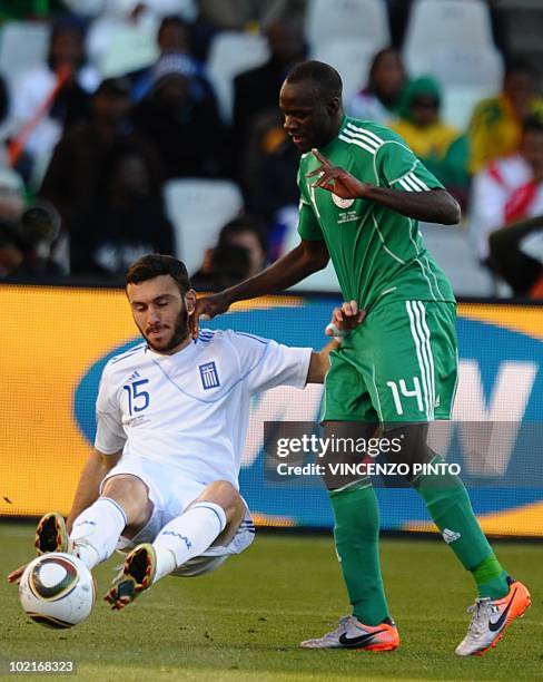 Greece's defender Vasilis Torosidis falls next to Nigeria's midfielder Sani Kaita during the Group B first round 2010 World Cup football match Greece...