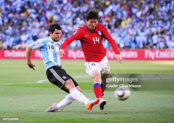 Sergio Aguero of Argentina tackles Lee Jung-Soo of South Korea during the 2010 FIFA World Cup South Africa Group B match between Argentina and South...