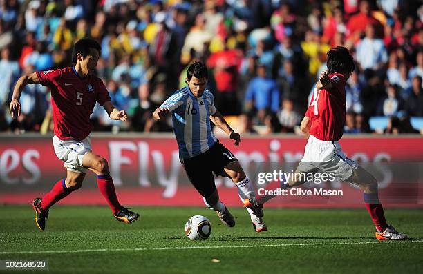 Sergio Aguero of Argentina takes on Kim Nam-Il and Cho Yong-Hyung of South Korea during the 2010 FIFA World Cup South Africa Group B match between...