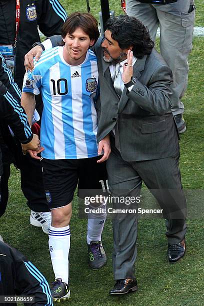 Diego Maradona head coach of Argentina talks with Lionel Messi of Argentina as they celebrate victory after the 2010 FIFA World Cup South Africa...