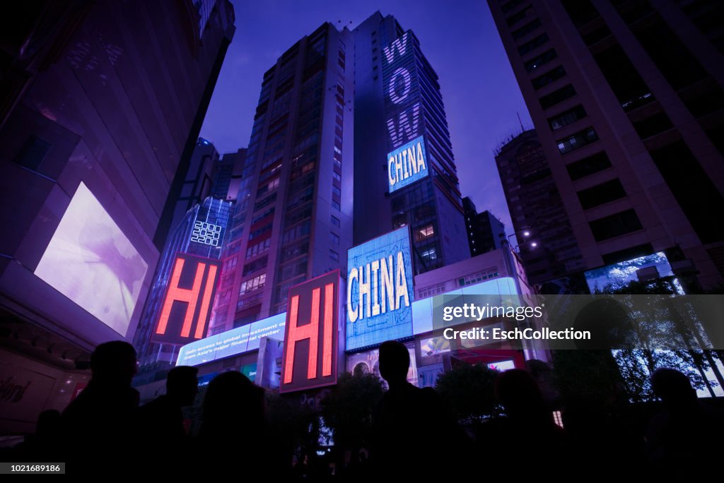 Hong Kong cityscape with Wow China and Hi China neon signs