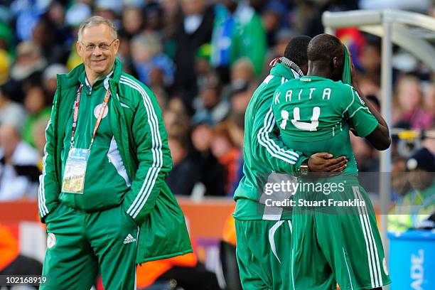 Lars Lagerback head coach of Nigeria watches as Sani Kaita covers his face as he walks off the pitch after being shown a red card during the 2010...