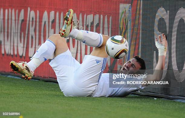 Greece's defender Vasilis Torosidis falls on the pitch after being kicked by Nigeria's midfielder Sani Kaita during the Group B first round 2010...