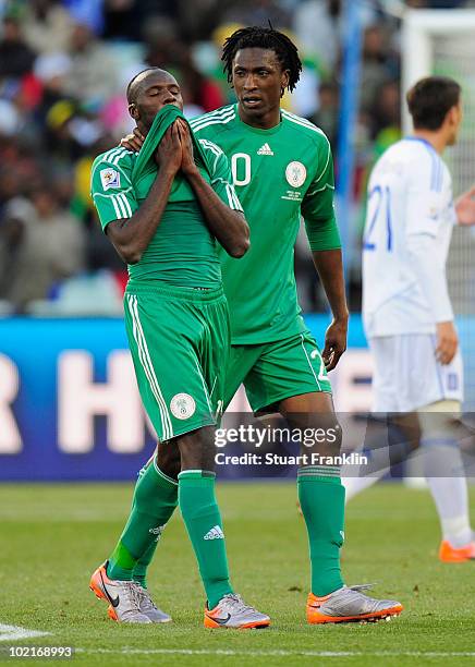 Dickson Etuhu of Nigeria consoles team mate Sani Kaita as he walks off the pitch after being shown a red card during the 2010 FIFA World Cup South...