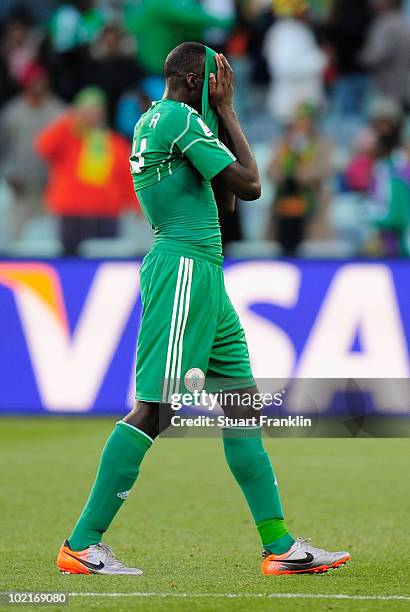 Sani Kaita of Nigeria covers his face as he walks off the pitch after being shown a red card during the 2010 FIFA World Cup South Africa Group B...