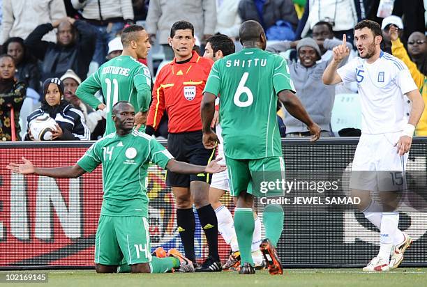 Nigeria's midfielder Sani Kaita reacts after tacking Greece's defender Vasilis Torosidis during the Group B first round 2010 World Cup football match...