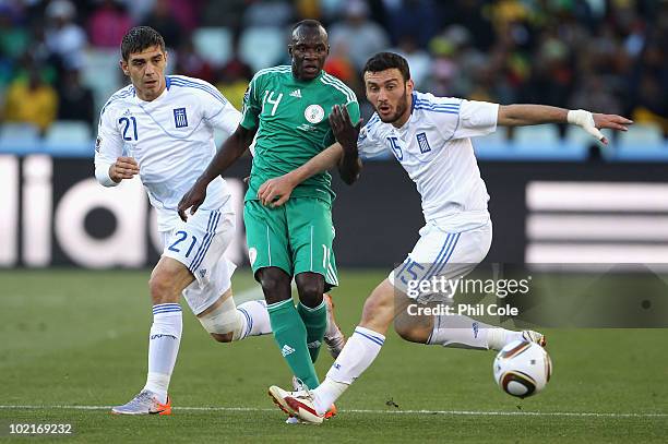 Vassilis Torosidis and Konstantinos Katsouranis of Greece close down Sani Kaita of Nigeria during the 2010 FIFA World Cup South Africa Group B match...